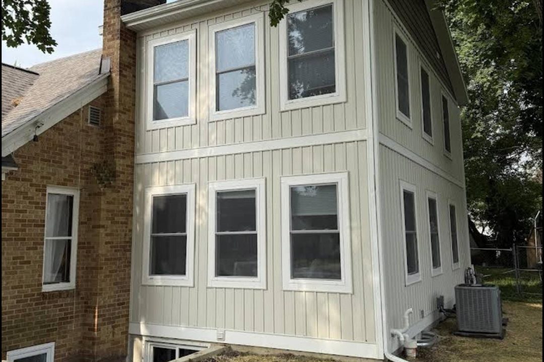 Two-story home addition completed by Grand Rapids Contracting in the Millbrook neighborhood of Grand Rapids, MI, featuring new siding and windows designed to blend seamlessly with the original home.
